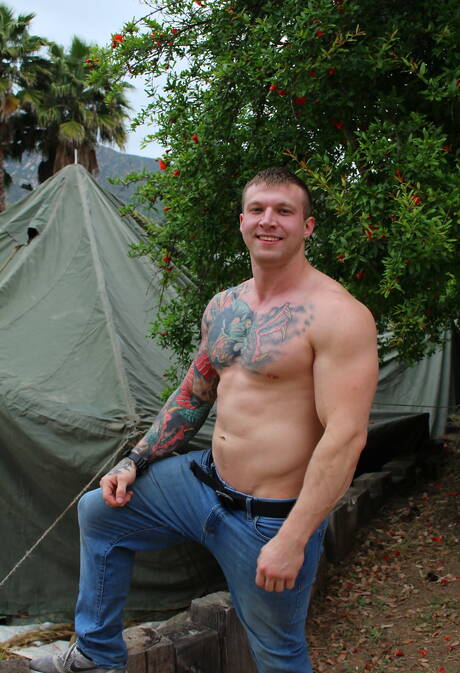 Bodybuilder Mike Johnson shows a sturdy body outdoor
